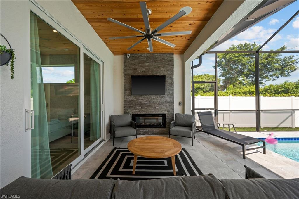 OUTDOOR LIVING ROOM WITH FIREPLACE AND TV