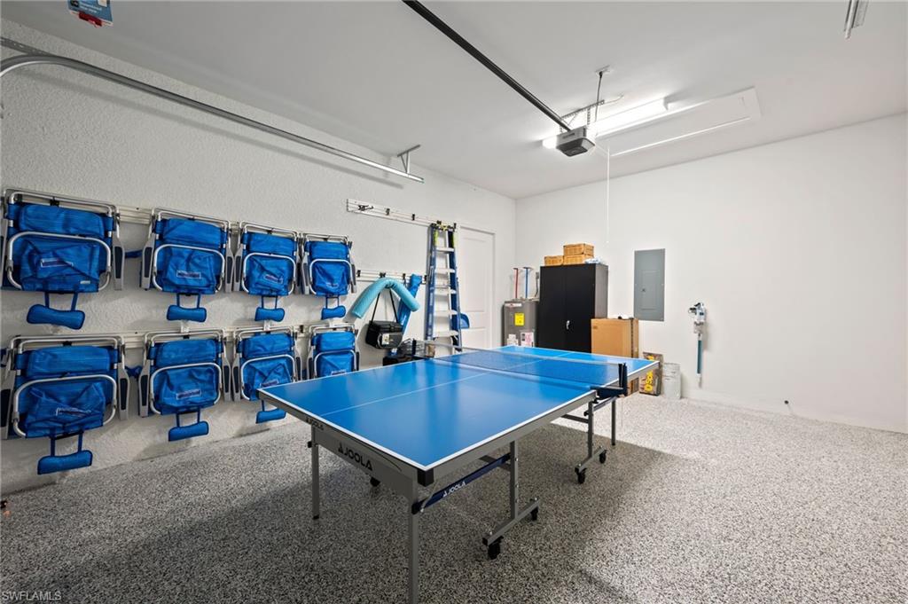 BEACH CHAIRS AND POOL TABLE IN GARAGE