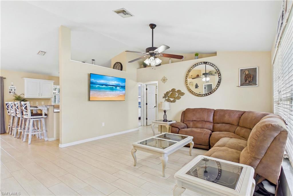 Spacious living area featuring vaulted ceilings