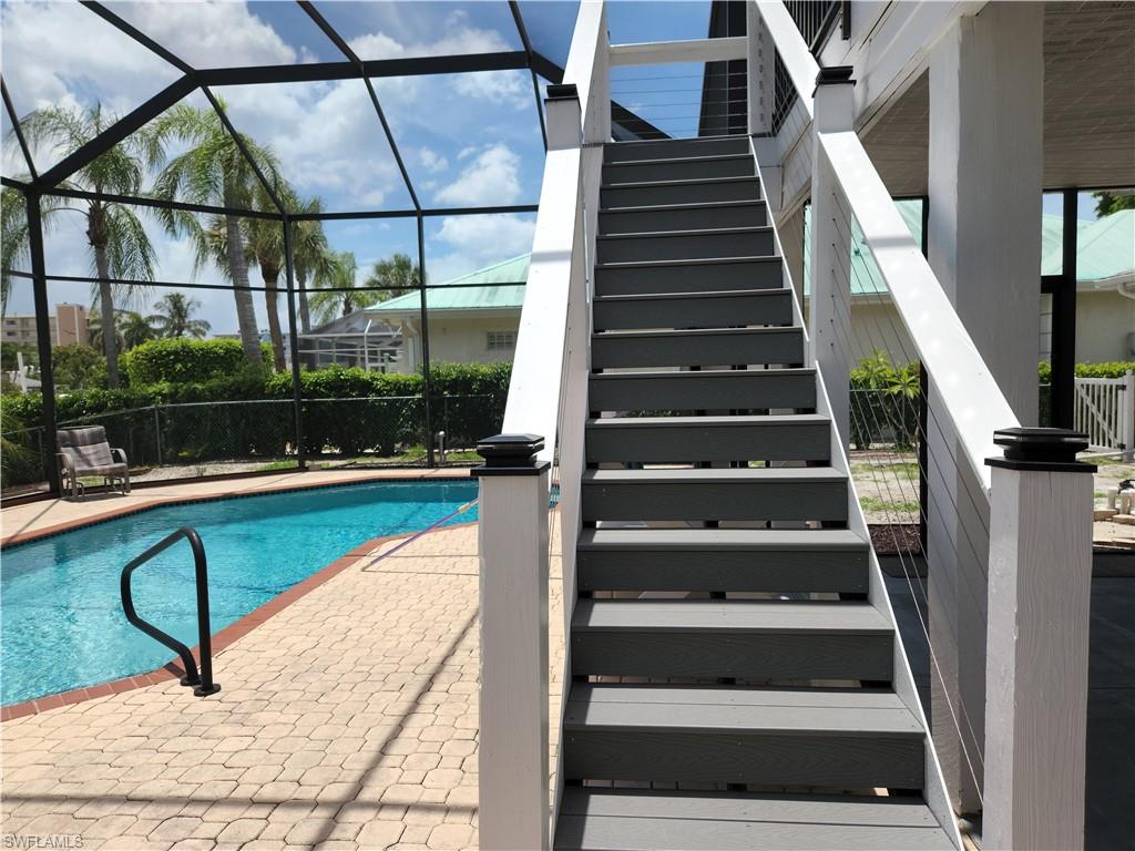 enclosed caged pool and stairs to 2nd level balcony