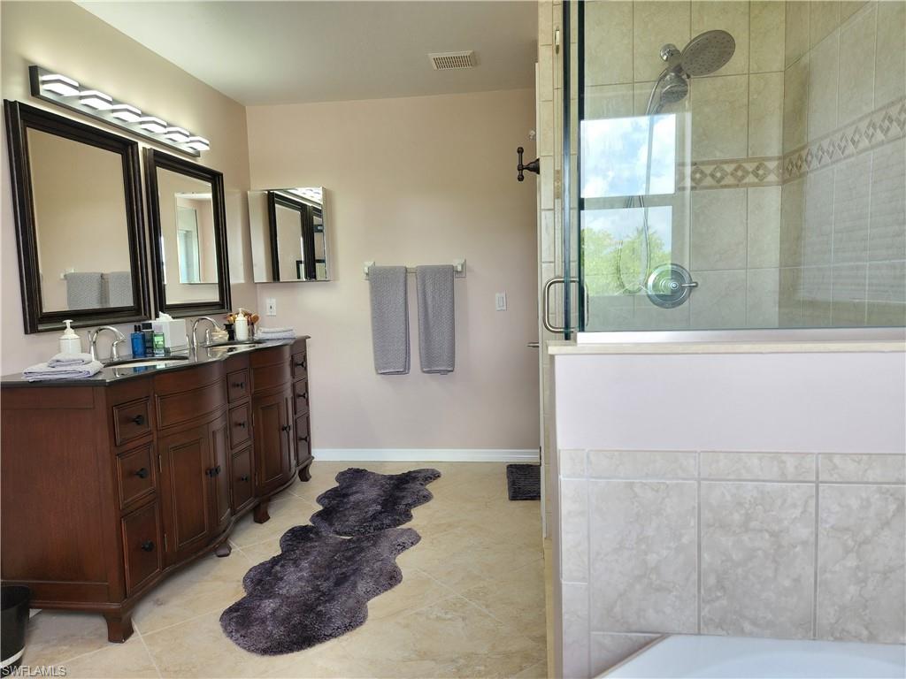 double sink vanity, separate walk-in shower and separate bathtub