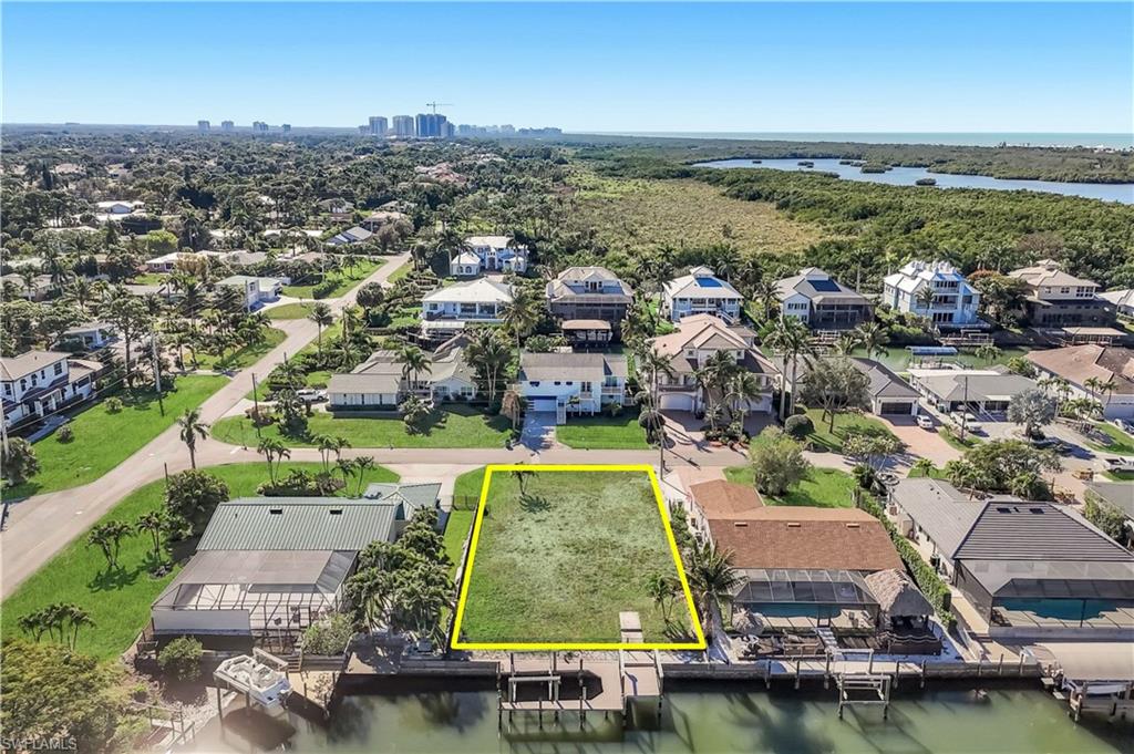 Waterfront lot with established seawall, private boat dock, and direct water access - Virtually Edited Image