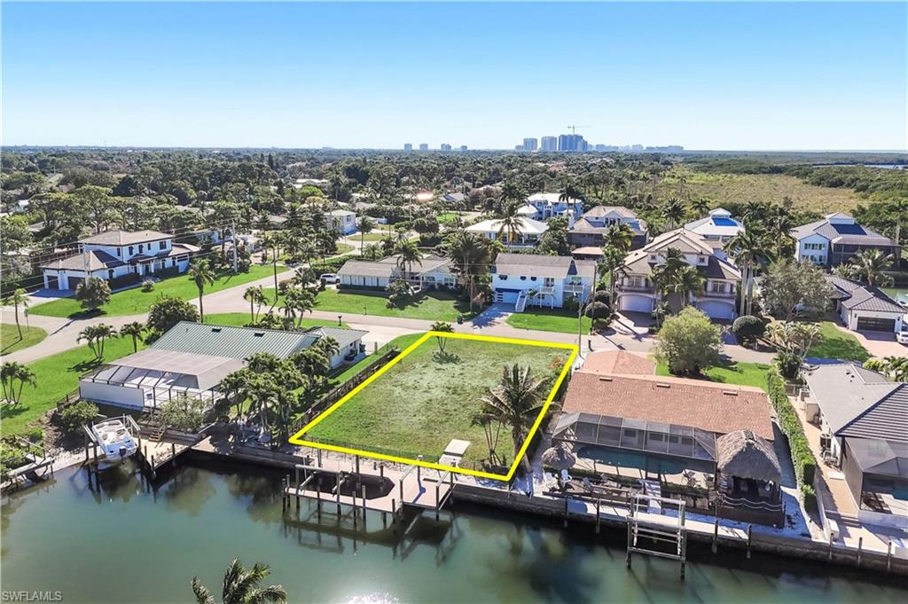 Waterfront lot featuring a cleared building site, existing seawall, and direct water access - Virtually Edited Image