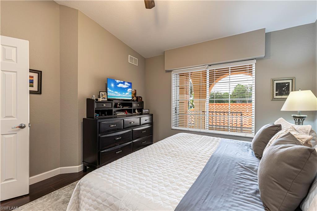 Room featuring rich wood-finish flooring and a vaulted ceiling