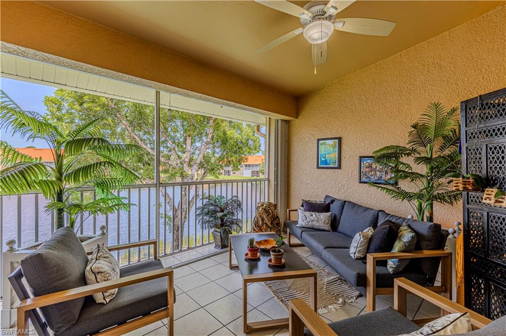 Screened balcony featuring textured walls and tiled flooring