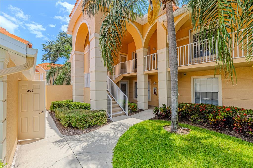 Multi-story building featuring stucco exterior and arched architectural details