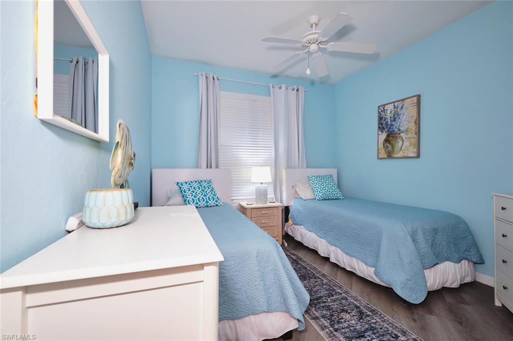Bedroom featuring dark wood-style flooring and a ceiling fan
