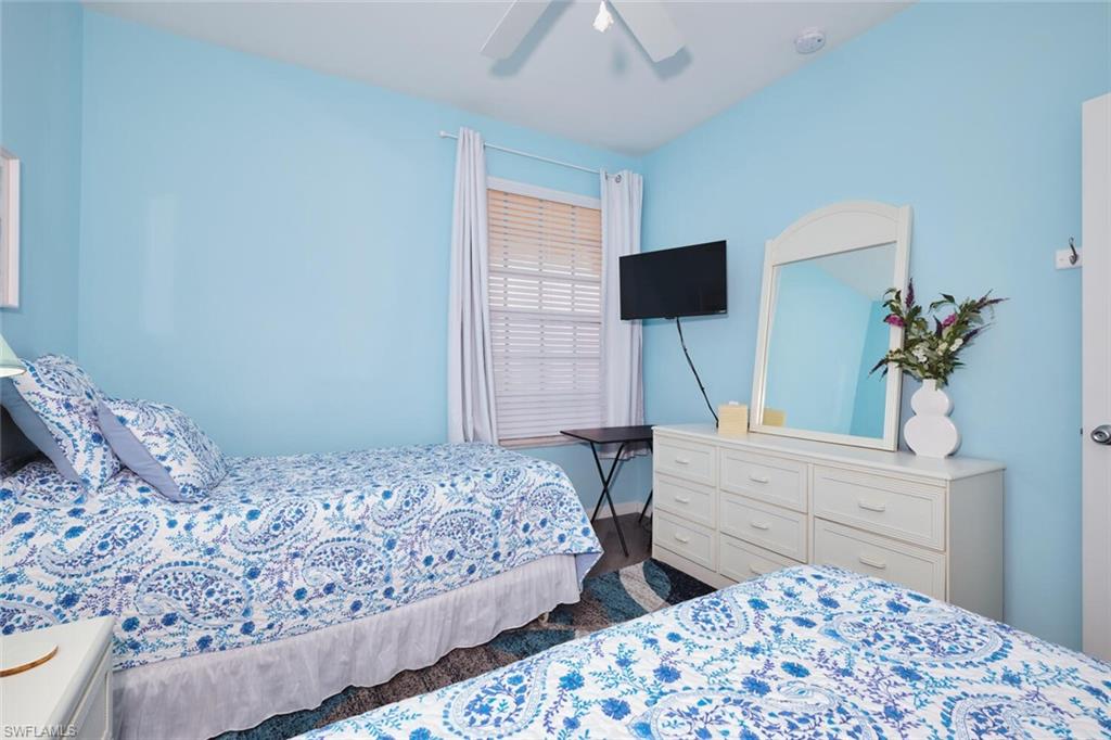 Bedroom with wood finished floors and a ceiling fan
