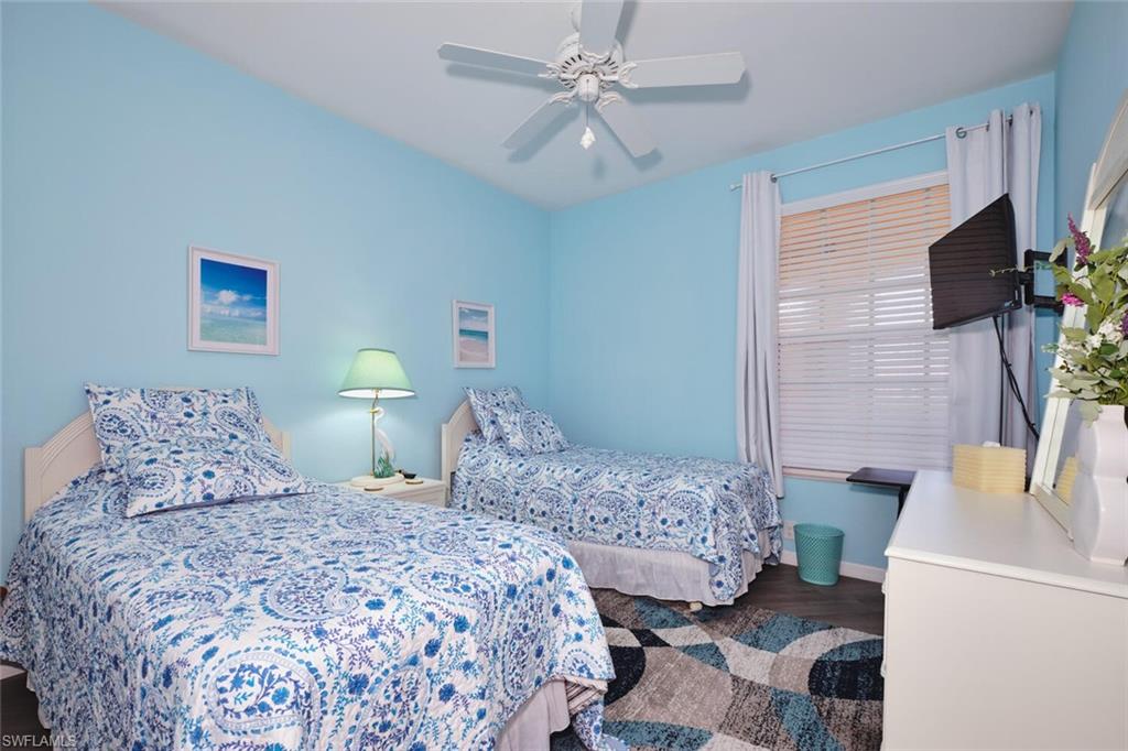 Bedroom with wood finished floors and a ceiling fan