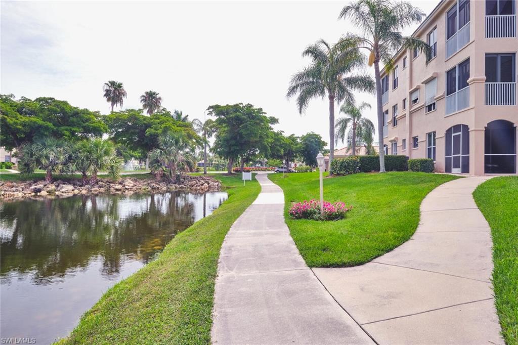 View of home's community featuring a water view and a lawn