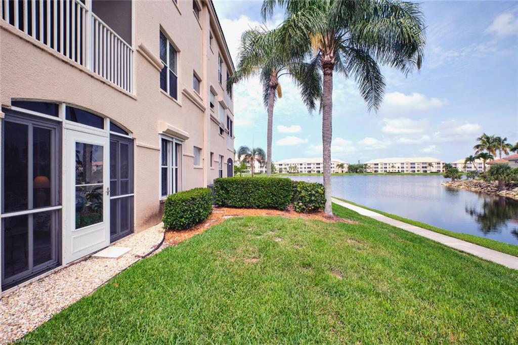 View of green lawn featuring a water view