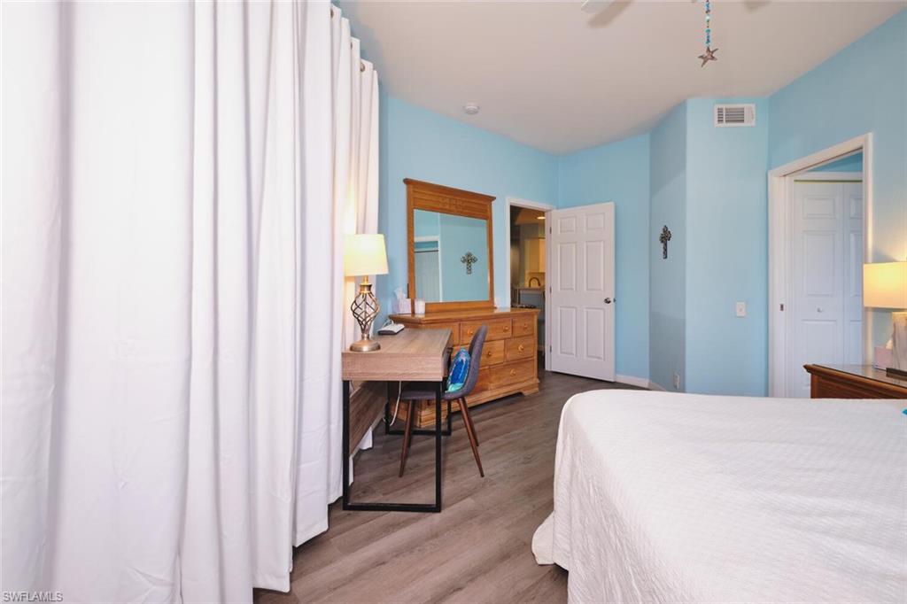 Bedroom with wood finished floors and a ceiling fan