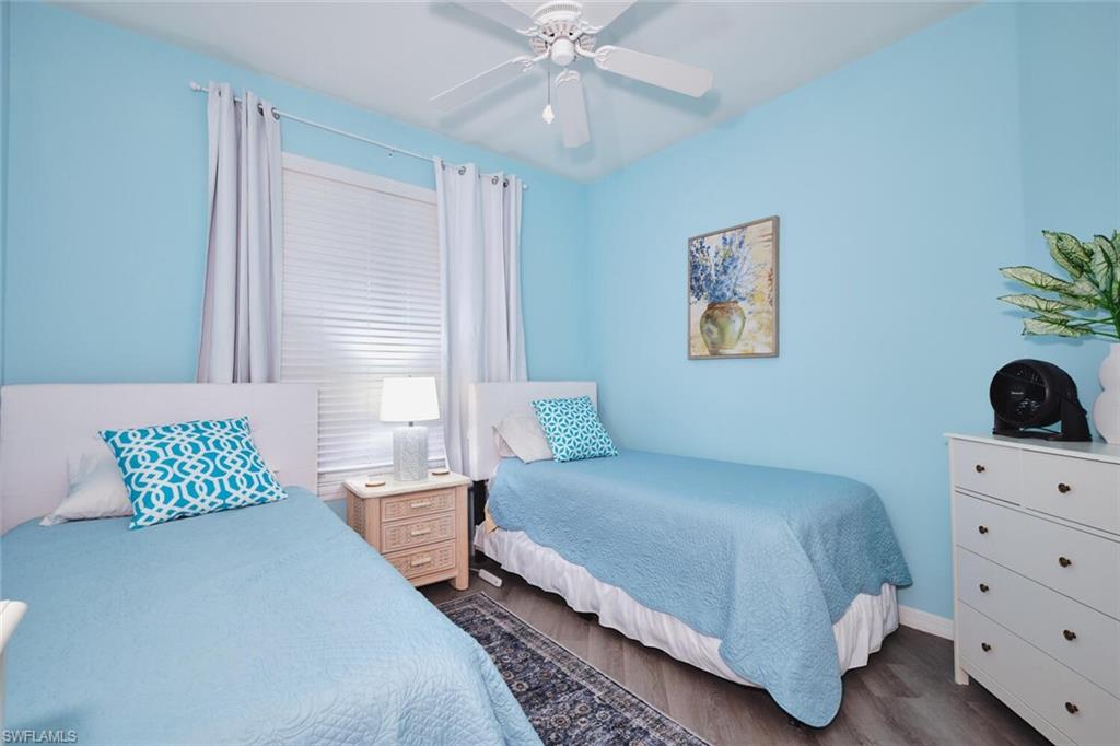 Bedroom with dark wood finished floors and ceiling fan