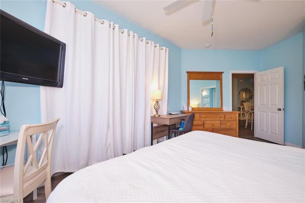 Bedroom featuring wood finished floors and ceiling fan