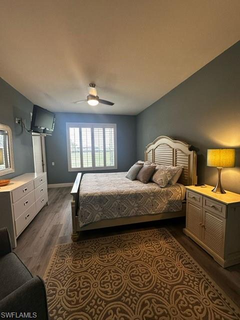 Bedroom featuring dark wood finished floors and a ceiling fan