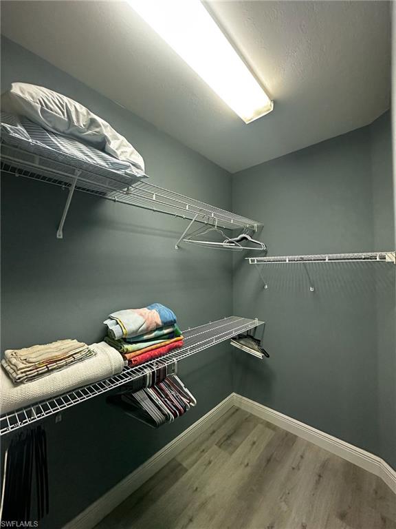 Walk in closet featuring wood finished floors