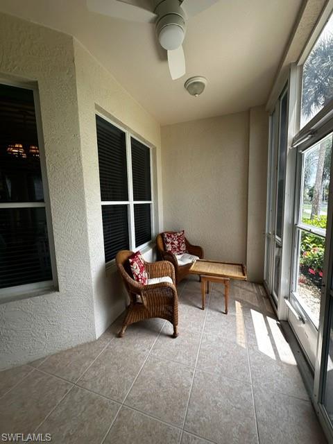 Sunroom with a textured wall and tile patterned flooring