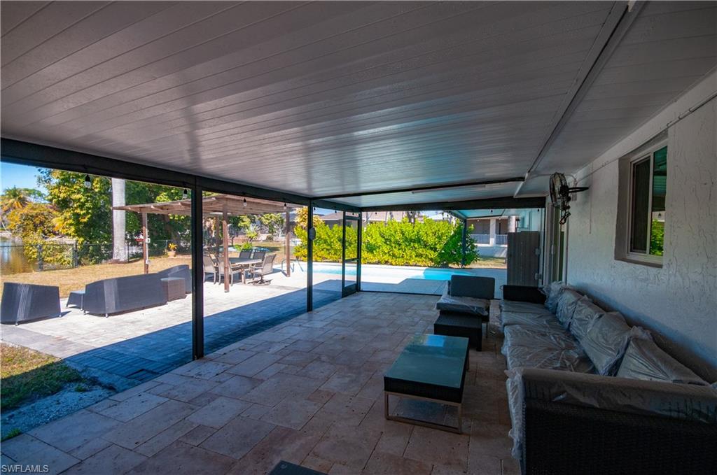 Fenced backyard with an outdoor living SCREENED space, a patio area, and an outdoor pool