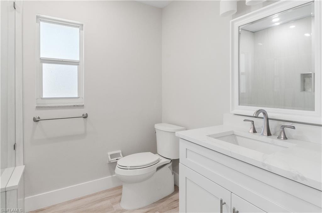 Bathroom #2 with vanity and light wood-style floors