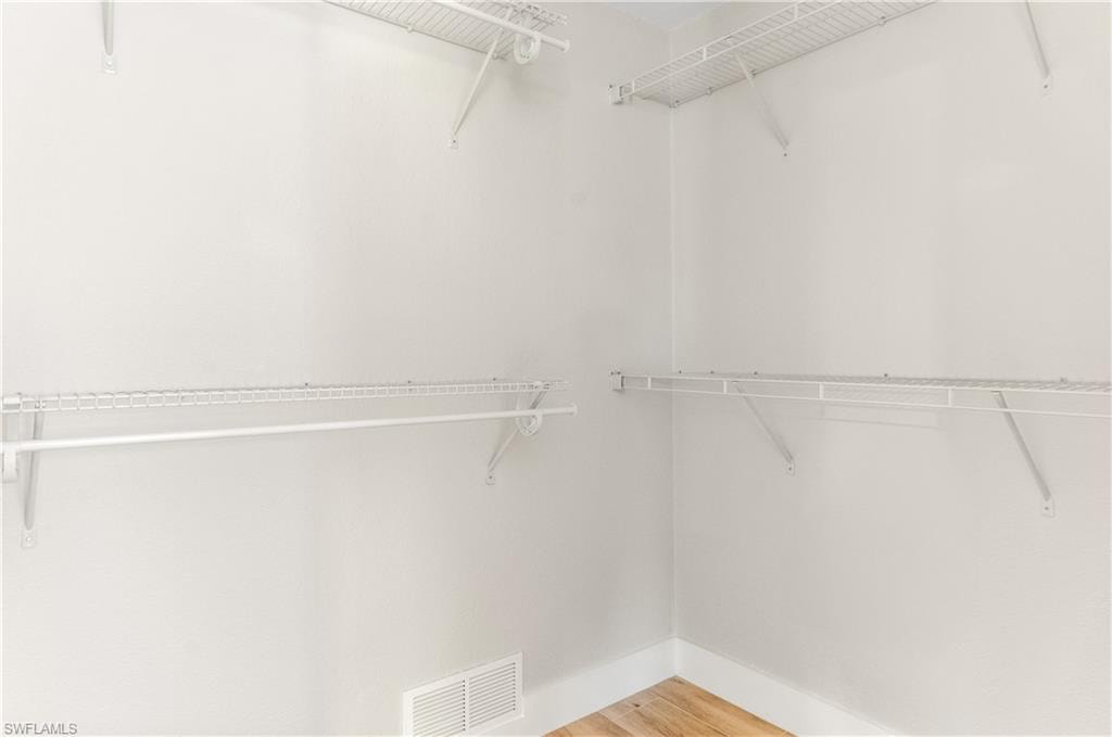 LARGE Walk in closet featuring light wood-style flooring
