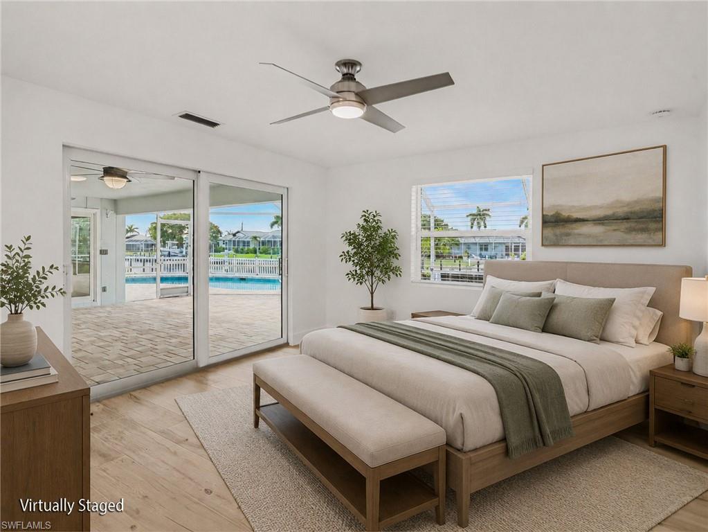 Primary bedroom has sliders to back lanai and overlooks the water (virtually staged)