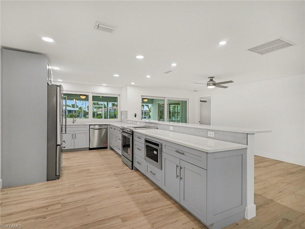 Enjoy your brand new kitchen overlooking the waterfront and lanai/pool area.