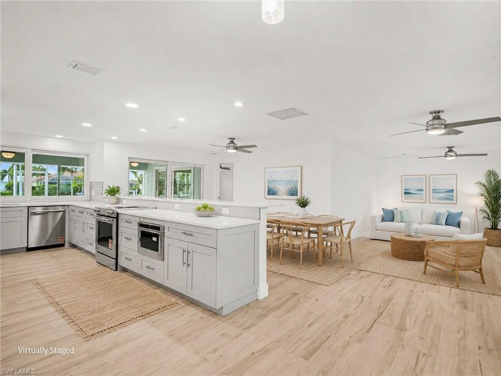 Open floor plan is great for entertaining - kitchen/dining room/living room, all opening up to lanai (virtually staged)