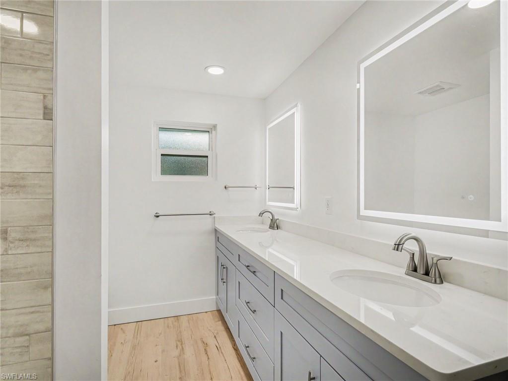 Second bathroom between bedrooms 2 & 3, with lots of cabinetry, shower/tub, linen closet in hallway