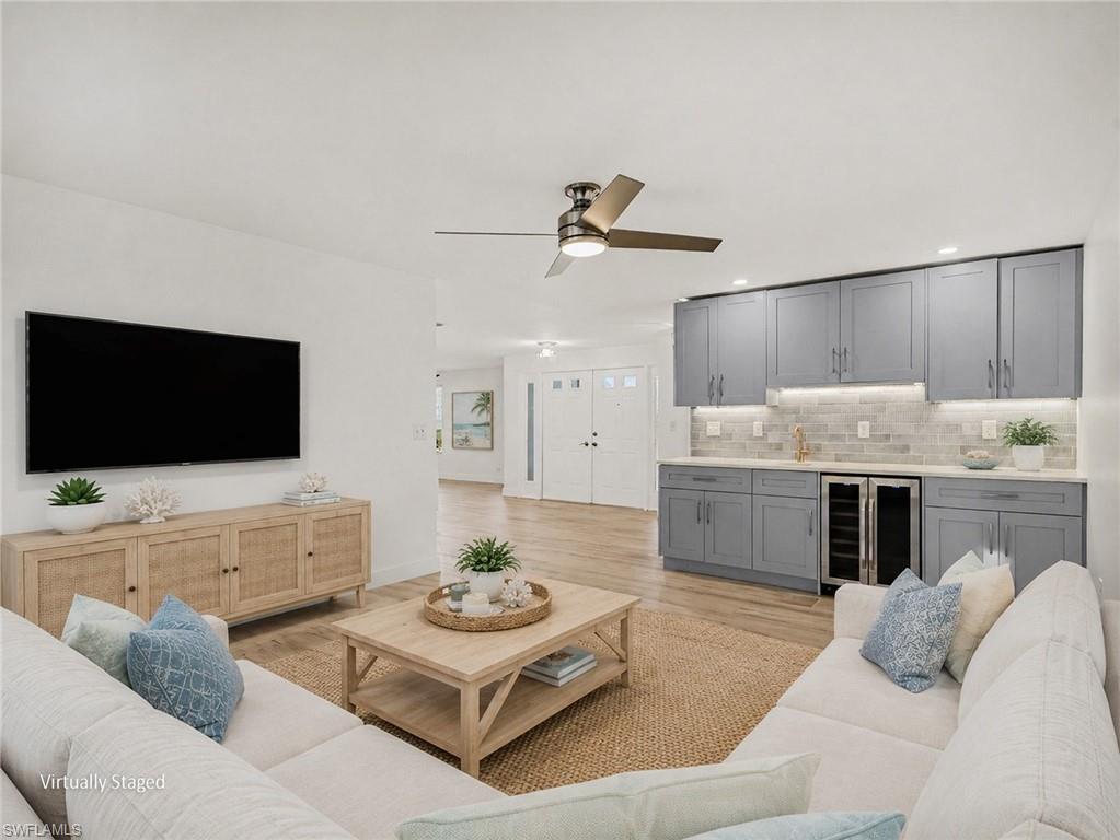 Large, open family room with wet bar to the left as you come in through the front door (virtually staged)