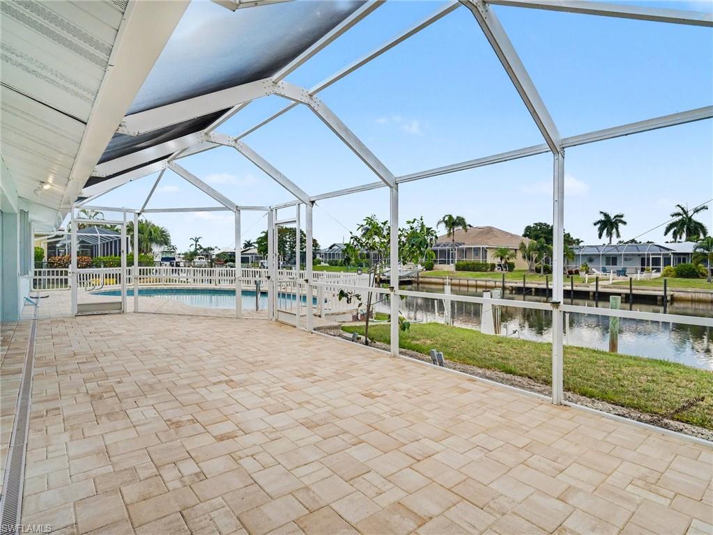 Back lanai extends out another 32 x 13 feet of screened in sun/lounging area overlooking the pool and canal