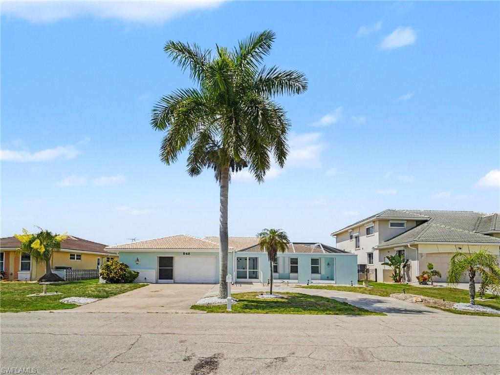 Front of home, oversized garaged, large circular drive, expansive screened in court yard