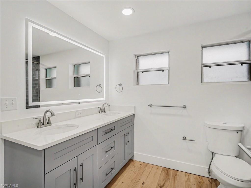 Primary bathroom has dual sinks and LED lighted mirror