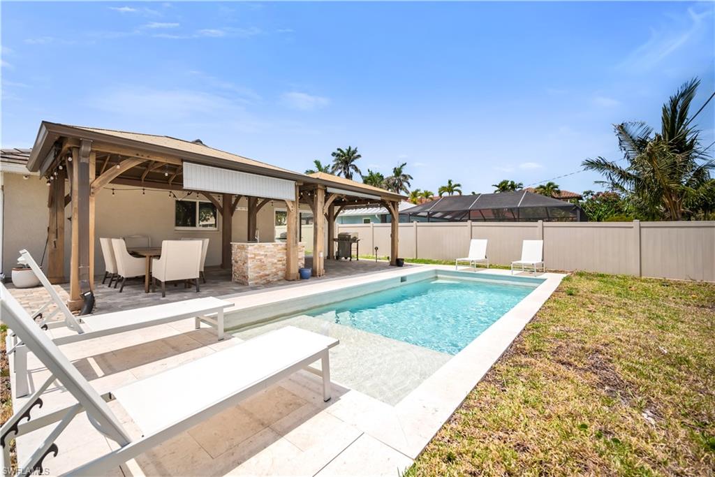 View of pool with a patio and a gazebo