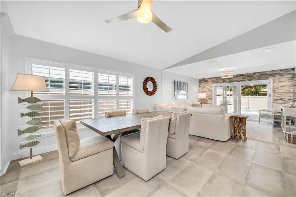 Dining room featuring vaulted ceiling and a ceiling fan