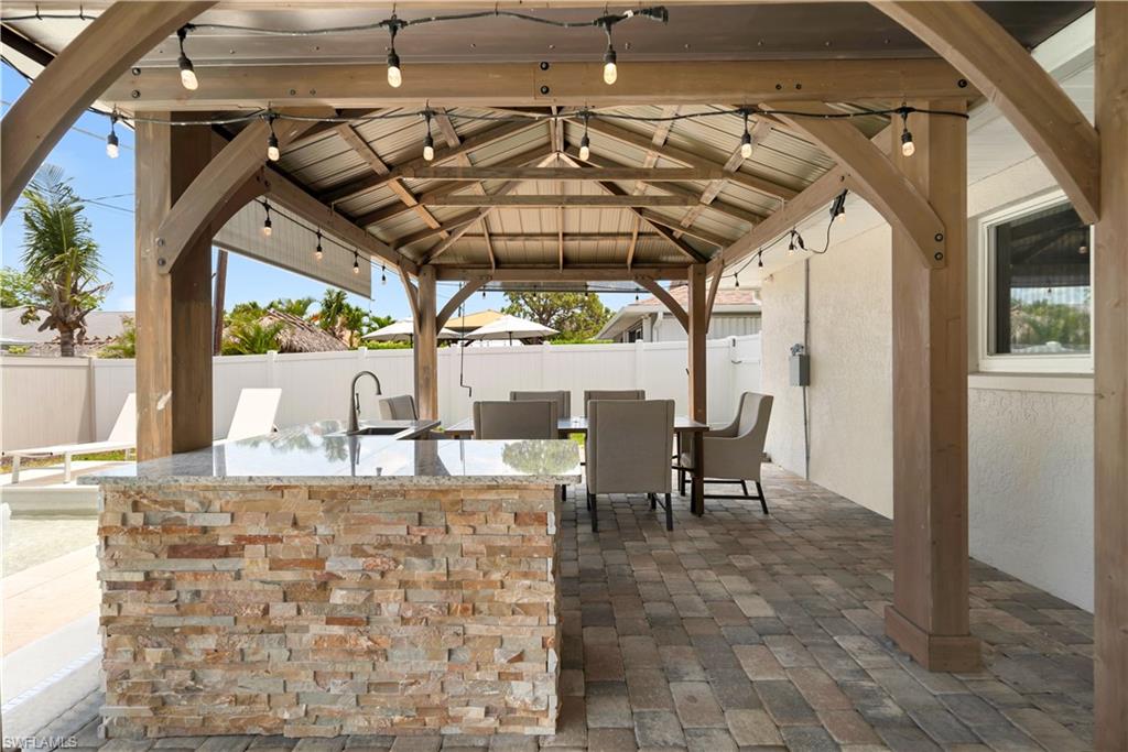 Fenced backyard featuring a gazebo and a patio area