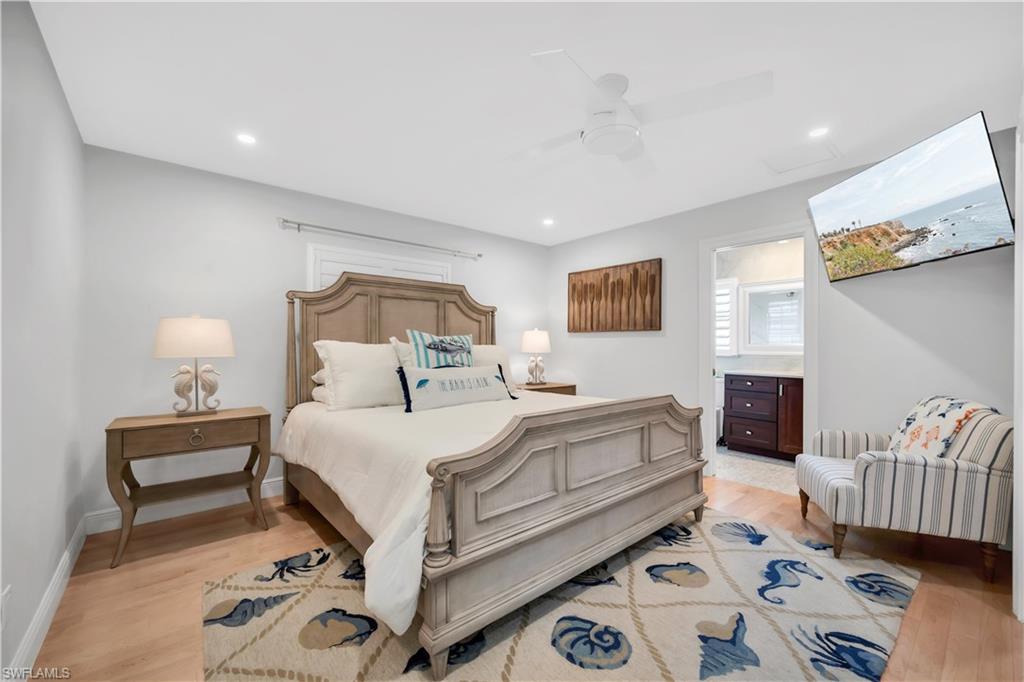 Bedroom featuring light wood-type flooring, a ceiling fan, baseboards, and recessed lighting