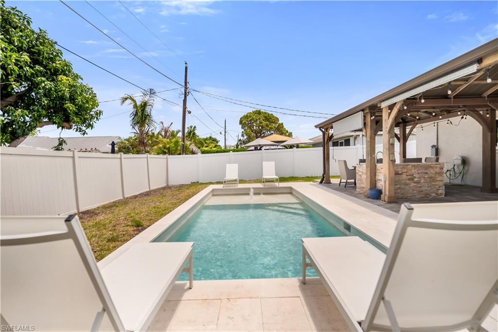 View of swimming pool with a fenced backyard and a patio area