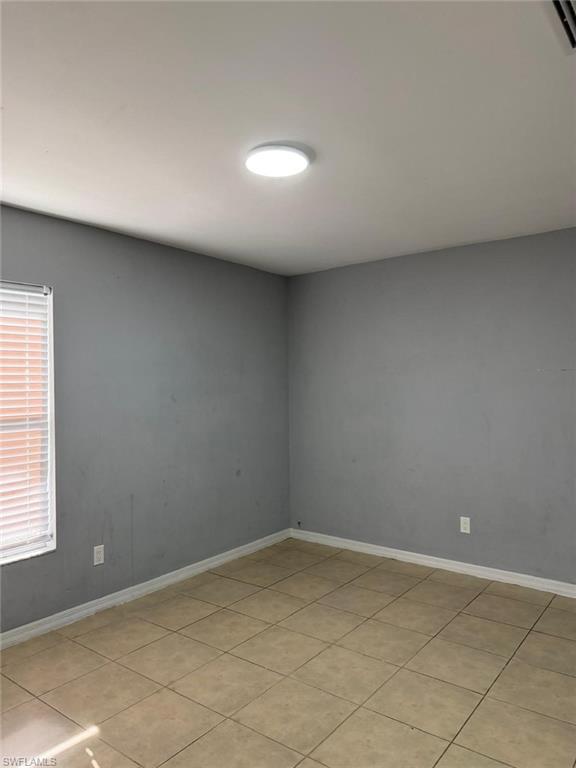 Neutral-toned tile flooring complements gray wall finishes