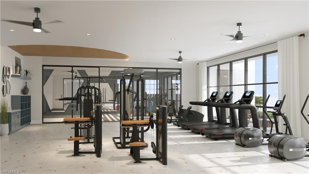 Fitness center featuring a range of cardio and strength training equipment, expansive windows, multiple ceiling fans, and a glass-enclosed workout studio