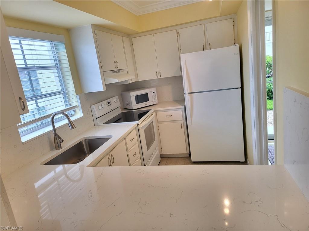 Kitchen with new sink Quartz counter tops and back splash and white cabinetry