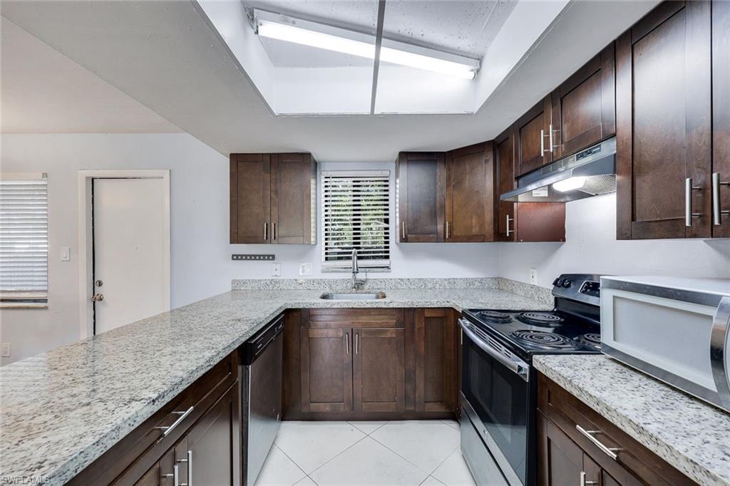 Kitchen features granite countertops and stainless steel appliances.