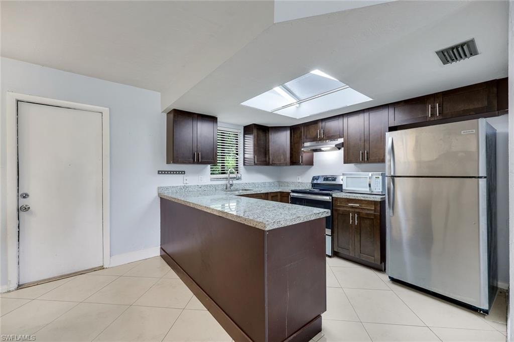 Access your private patio through the kitchen door...perfect for dining alfresco!