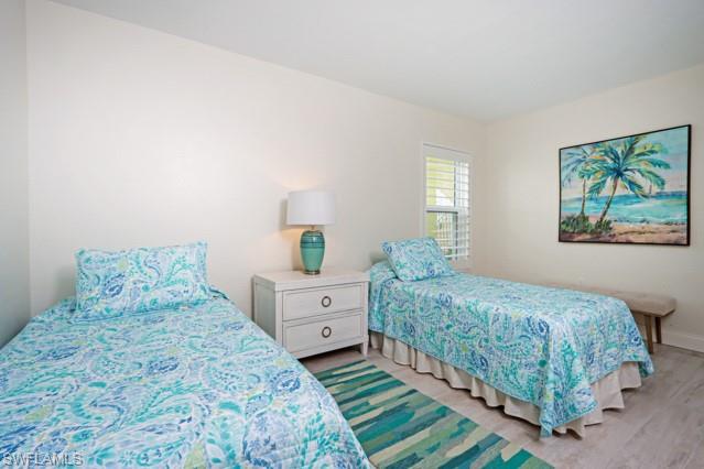 Bedroom featuring light wood finished floors and baseboards