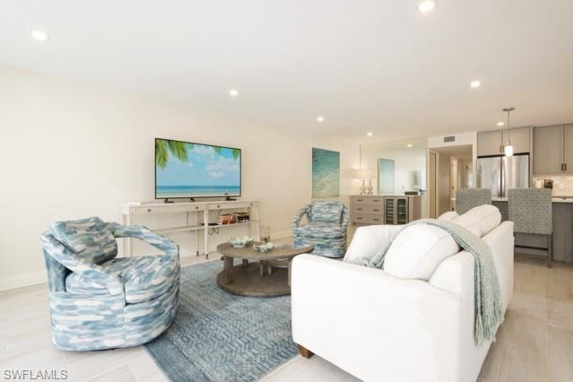 Living area with recessed lighting and wine cooler