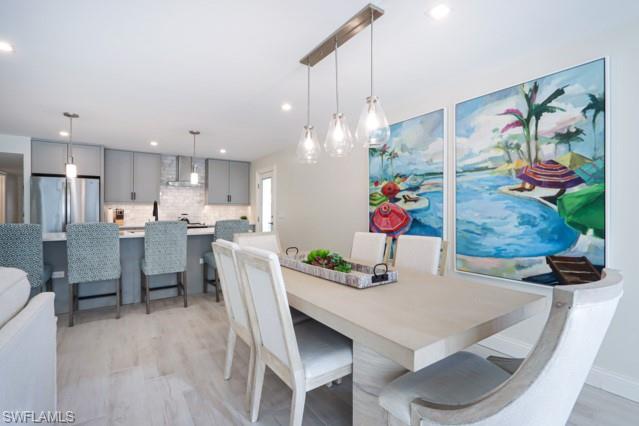 Dining area featuring light wood-type flooring and recessed lighting