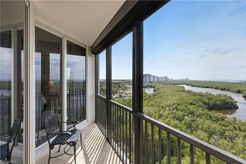Balcony with a water view and a sunroom
