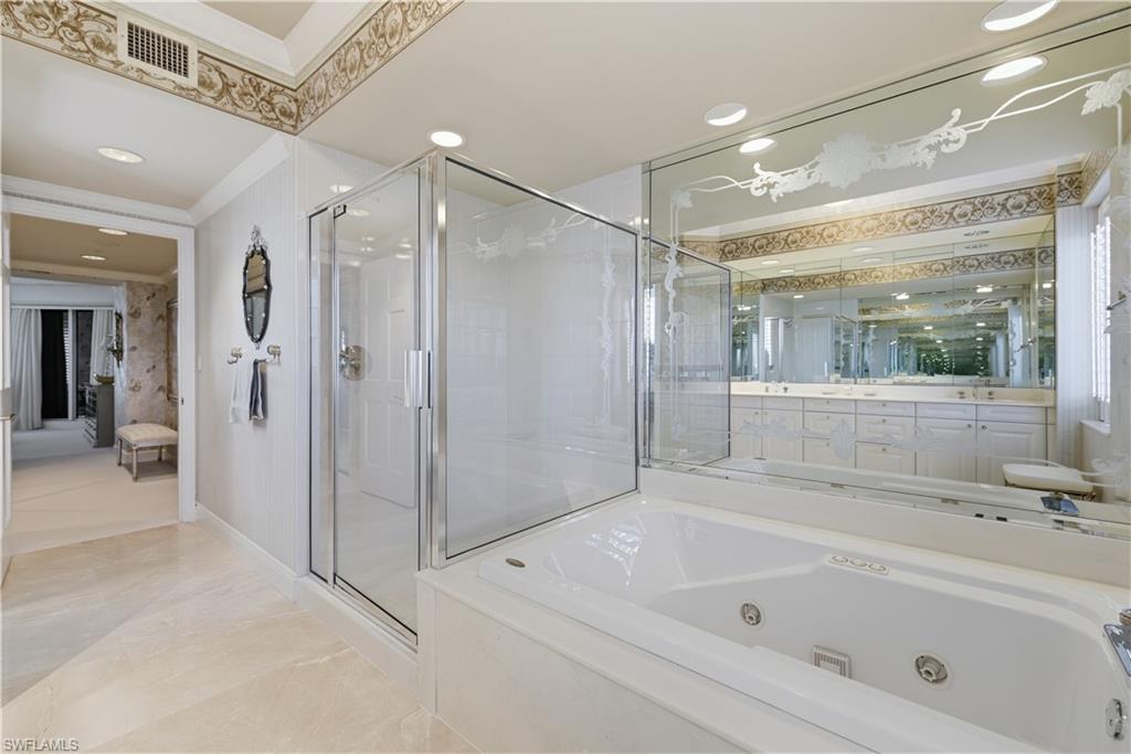 Ensuite bathroom featuring a tub with jets, a stall shower, recessed lighting, crown molding, and vanity