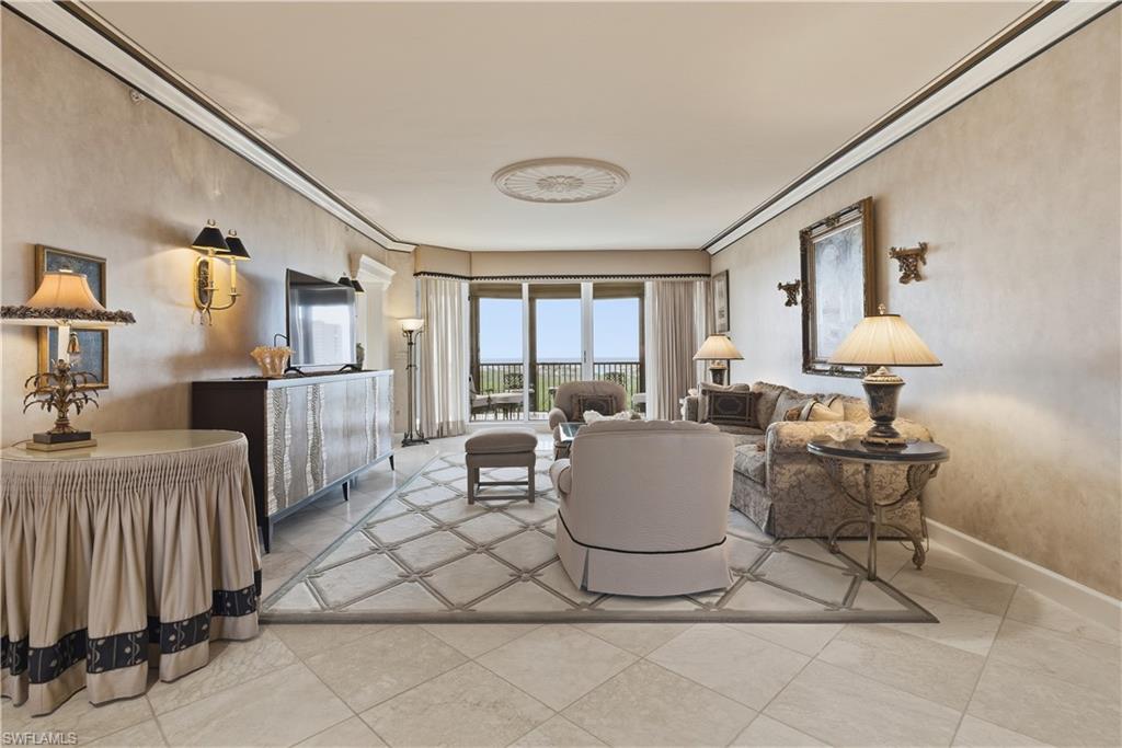 Living room featuring ornamental molding and light tile patterned floors