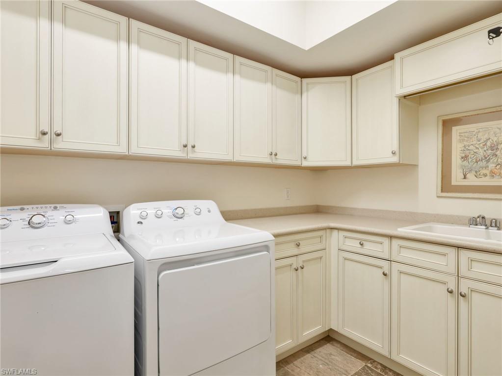 Laundry area featuring ample storage and a built-in utility sink.