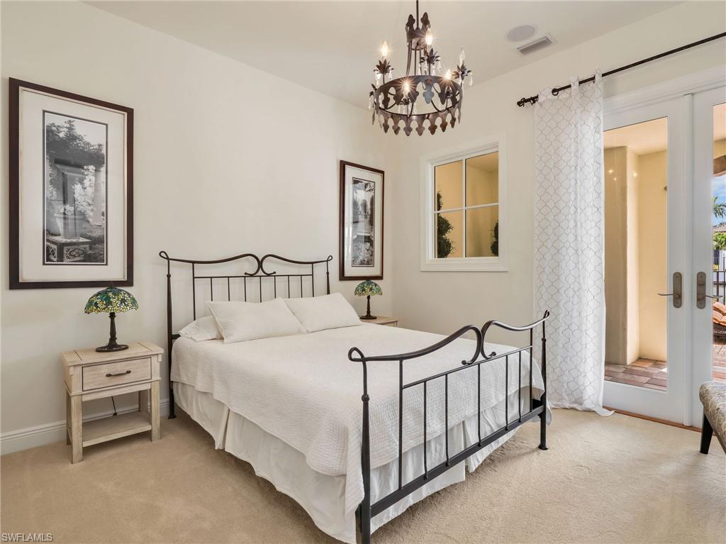 Guest Bedroom on ground floor with doors heading out to the private pool/spa